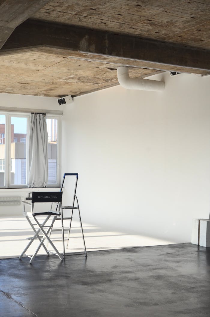 Bright and spacious loft interior featuring minimalist design and natural sunlight.